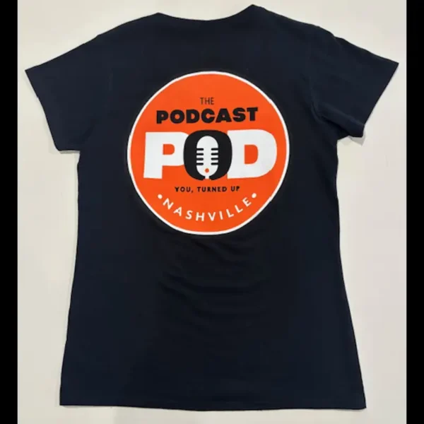 Back of women’s black Podcast Pod Nashville v-neck t-shirt with bold orange circular logo and "You, Turned Up" slogan