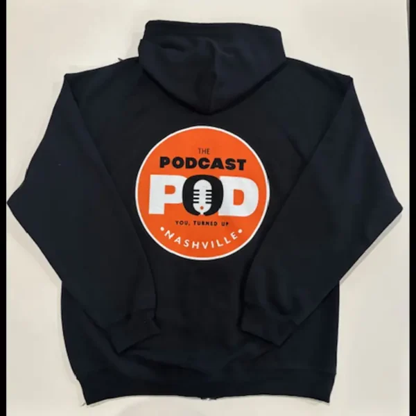 Back of black Podcast Pod zip-up hoodie featuring bold orange circular logo with microphone and "You, Turned Up" slogan