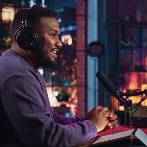 Man podcasting with headphones and microphone in a professional studio setting near Forest Hills, TN at The Podcast Pod in Brentwood