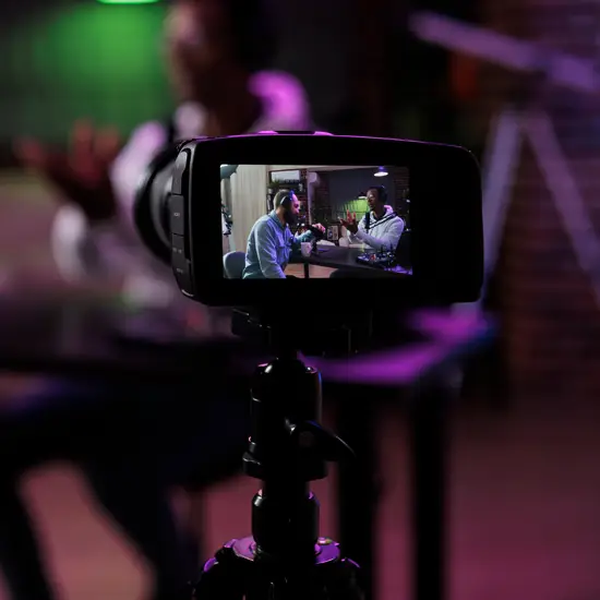 Video camera recording two podcasters in conversation at a professional studio near Franklin, TN at The Podcast Pod in Brentwood