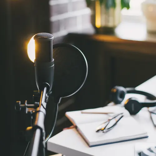 Professional podcast microphone with pop filter on a lit desk setup at The Podcast Pod near Oak Hill, TN